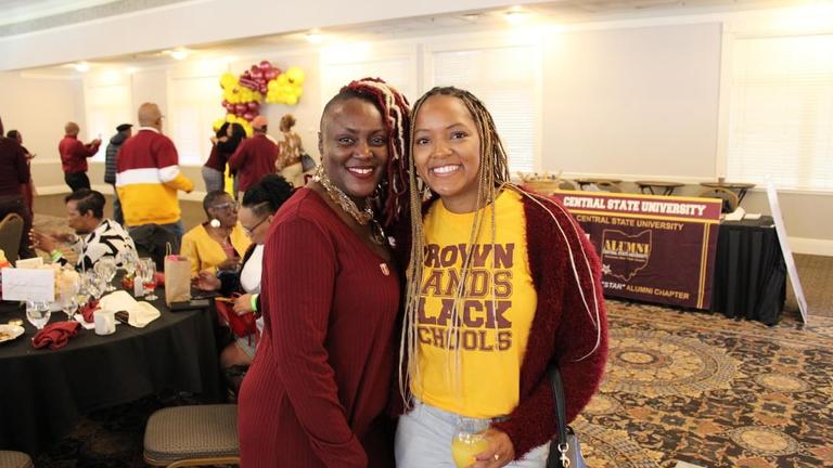 two central state university alumni wearing their maroon and gold