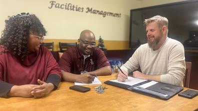 three people gather in a facilities management conference room at central state university