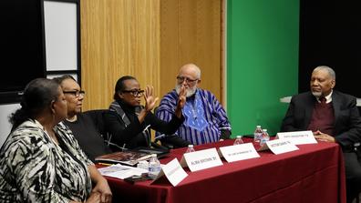five panelists including alumni faculty and staff sit around a table discussing the 1974 tornado at central state university