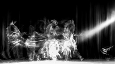 black and white photo of a dancer in motion on stage