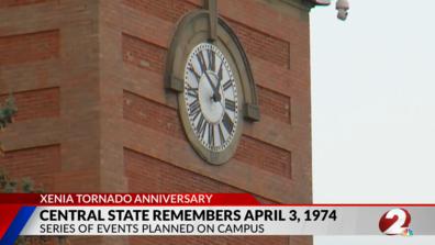 a screenshot from channel 2 news showing the central state university alumni tower with a banner about the 1974 tornado