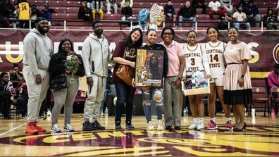 members of the central state university women's basketball team stand together for a photo on the court