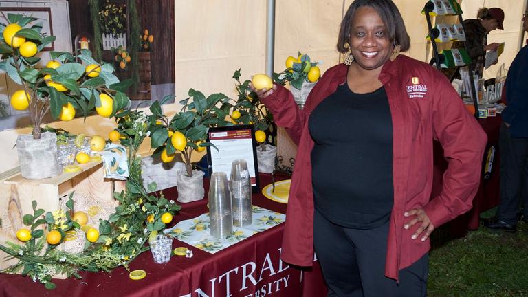 A Black Central State University Land-Grant staff member holds a lemon to make lemonade.