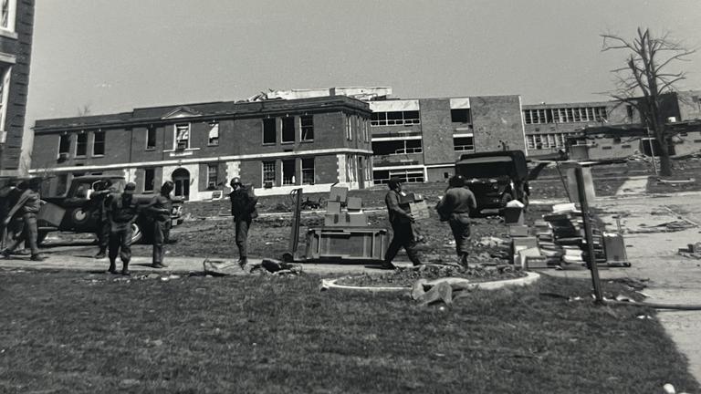 a black and white image of the national guard on the central state university campus after the 1974 tornado