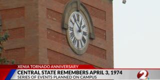 a screenshot from channel 2 news showing the central state university alumni tower with a banner about the 1974 tornado