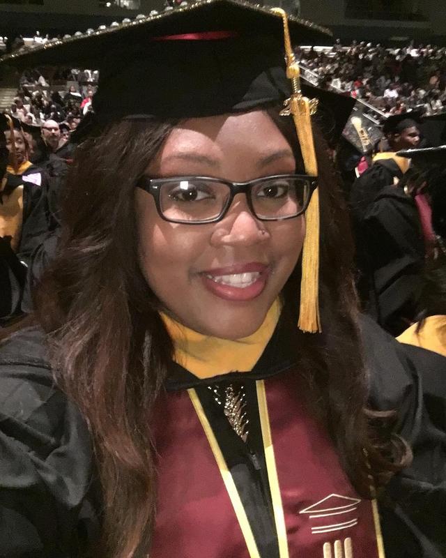 a Black woman in graduation regalia at central state university