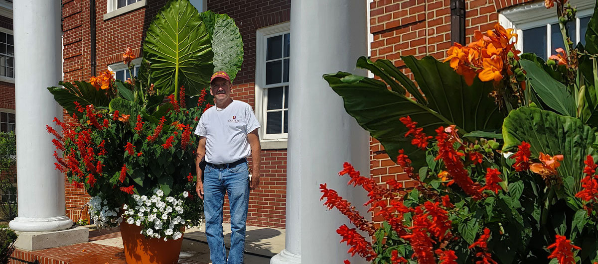 CSU plant technician Brian Kampman shown with the Aceae Colocasia plants that he raised, are also known as Elephant Ears. Photo by Dr. Morakinyo A.O. Kuti