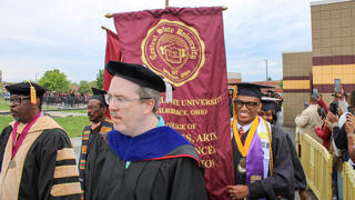 faculty approach the stage