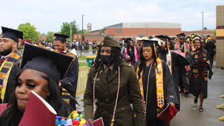 graduates walk in procession