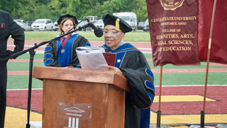 a faculty member speaks at the lecturn