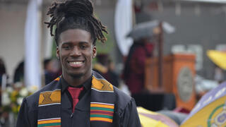 a graduate smiles