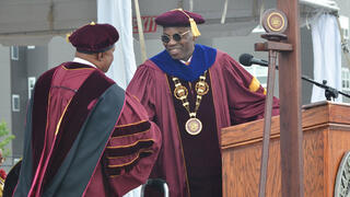 President Kuti stands on stage