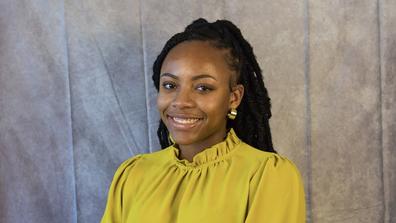 NyAshia Williams Matthews wearing a yellow blouse