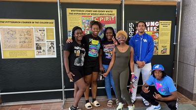 Central State University students pose beside a display of The Golden Age of Black comics at the National Afro-American Museum & Cultural Center on the campus of Central State in Wilberforce, Ohio