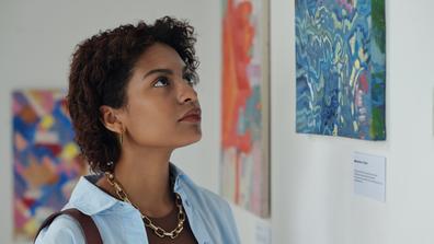 a young person looks at art in a museum