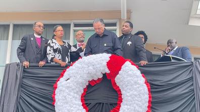 seven people, including Cameron Barnes, participate in the Lorraine Motel Wreath Laying Service in April 2022