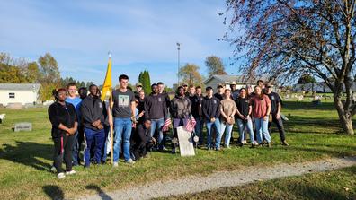 cadets from Central State University WROTC Battalion congregate around the burial site of Lt. John Hanks Alexander, the second African American to graduate from the United States Military Academy at West Point