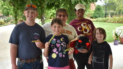 youth participating in the Homeschool Adventures program by Central State University Extension pose with some of the plants they helped grow with Extension Associate Clare Thorn at the Seed to Bloom Botanical and Community Garden
