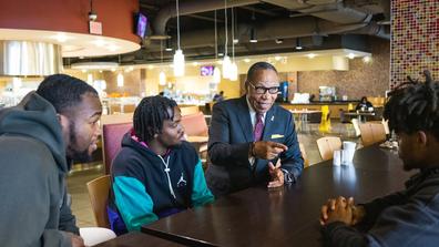 central state university interim president talks with students in the university student center