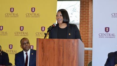 Danielle Darkenwald speaking at podium
