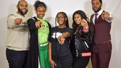 a group of central state university students point at the camera