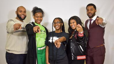 a group of central state university students point at the camera