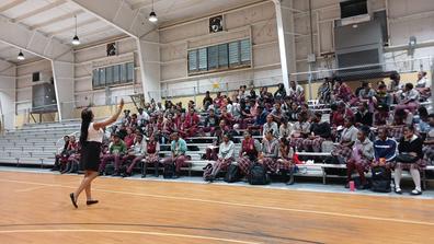 Ashley Clarke of Central State University pumps up a crowd of high school students on a recruiting trip