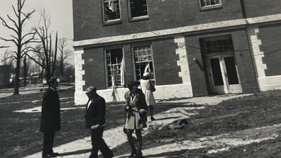 1974 tornado survivors stand outside a mostly intact building on the central state university campus but whose windows have been destroyed