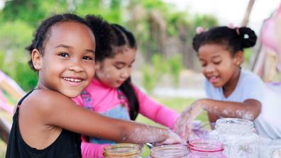 three young people explore science during a summer camp