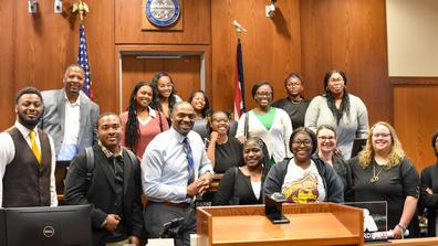 a large group from central state university and officers at montgomery county common pleas court behind a judge's seat