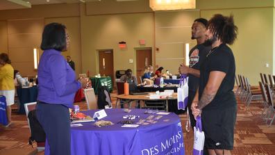 two central state university student-athletes stop by a des moines medical school table in the university student center