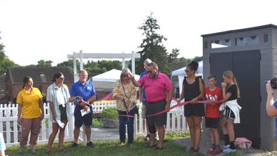 ribbon cutting for brighton grows community garden