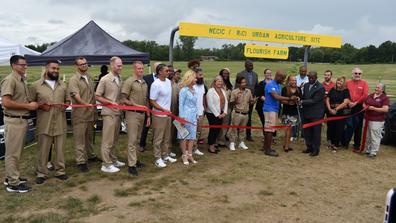 participants in a ribbon-cutting ceremony for an expanded urban farming and teaching program led by central state university extension at richland correctional institution in mansfield ohio
