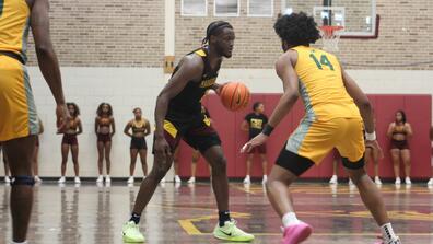central state university men's basketball player dribbles in front of a kentucky state player