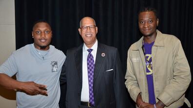 an older black man with two young black men