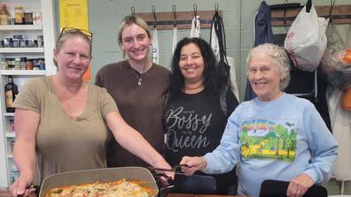 four adults show their meal during a healthy cooking class in cincinnati ohio with central state university extension