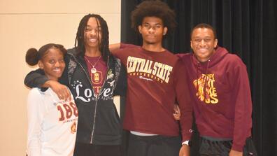 four freshmen stand with arms around each other during the keybank scholars program at central state university