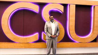 Student Ombudsman Marc DeWitt in front of CSU sign in student center