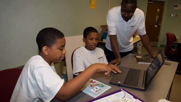 participants in the verizon minority male program youth development at central state university in wilberforce, ohio, work with faculty members and Marauders to develop new skills