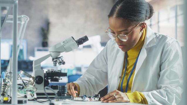 Woman works with a microscope