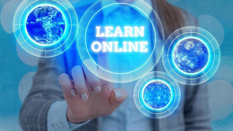 Learn Online --woman reaching out to touch digital abstract globes