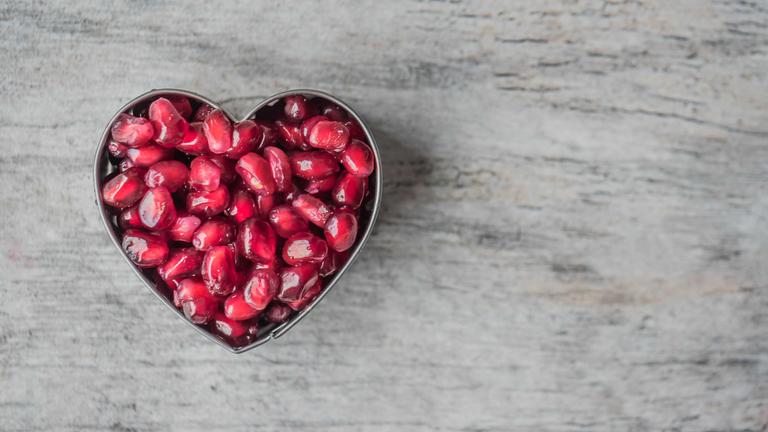 a heart-shaped bowl with cranberries