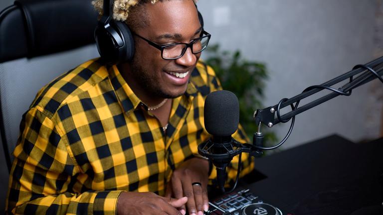 A young person operates equipment in a radio station