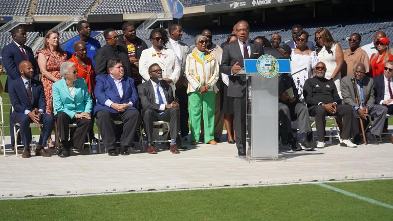 Central State University Interim President Dr. Alex Johnson speaks at the podium at Soldier Field for the Chicago Football Classic