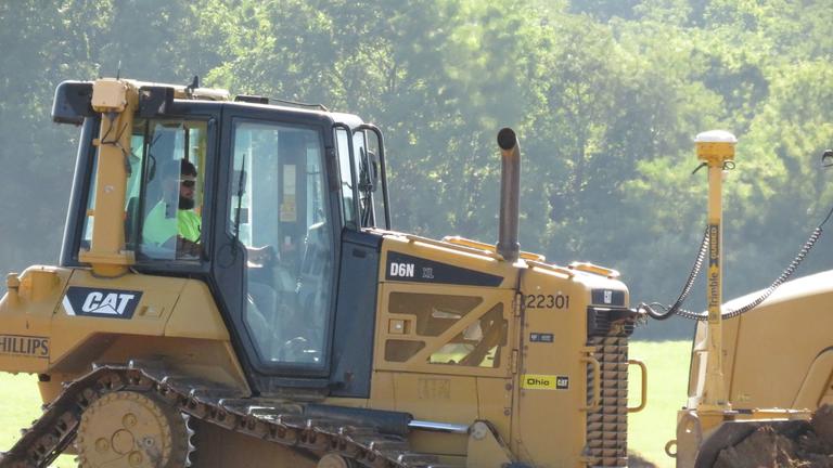 A tractor works at the site of a new research facility at Central State University