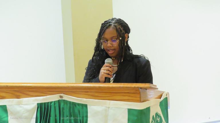 a presenter at a podium for youth camps hosted by Central State University, an HBCU
