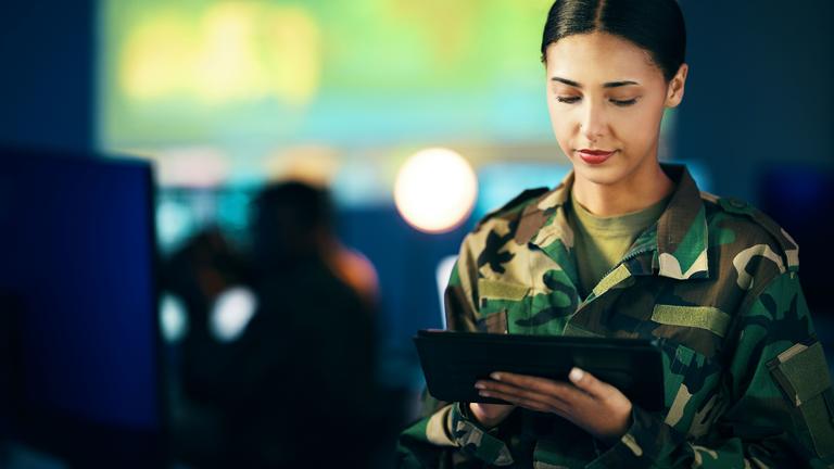 Military, woman and working with tablet in surveillance, control room or technical support for army, officer or mission. USA, cybersecurity and person with online database, research or communication