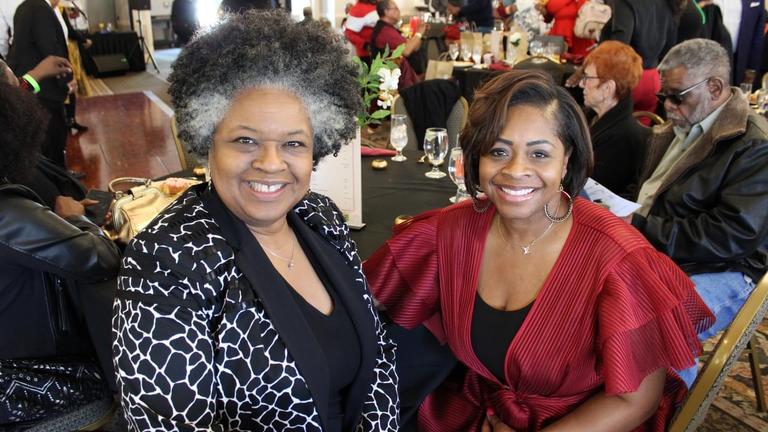 two people sit in a packed room during the cincinnati star alumni chapter annual scholarship brunch