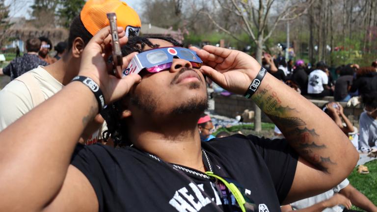 a person watches the eclipse