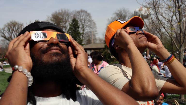 two people look up to see the solar eclipse